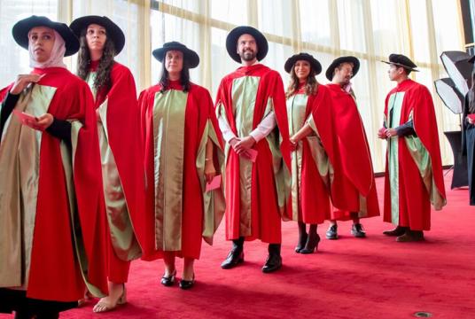 graduating students in red doctoral robes