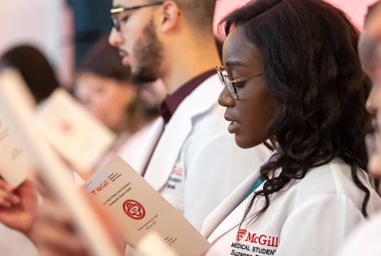 A group of people attending the white coats ceremony