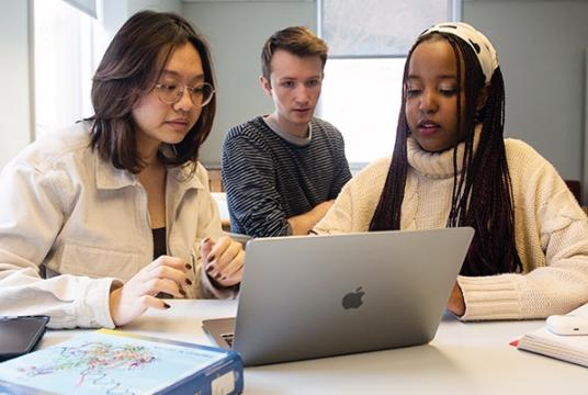 Students working together at a laptop